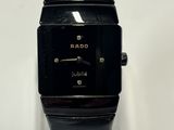 a close up of a black watch on a clear display