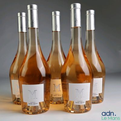 four bottles of wine are lined up on a table