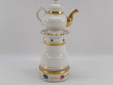 an image of a white tea pot with gold trim and flowers on it