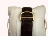 a white pillow with a gold buckle on it