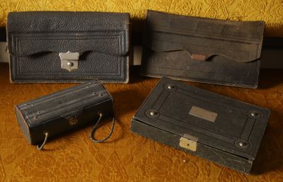 three black leather cases sitting next to each other on a table