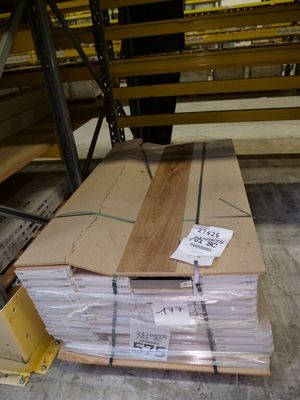 a large stack of wood sitting on a pallet in a warehouse