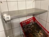 a red basket full of garbage in a public bathroom