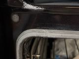 someone is cleaning the inside of an oven with a rag
