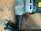 a drill with a cord attached to it sitting on the floor