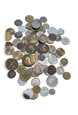 a pile of old coins on a white surface