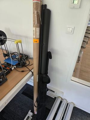 un tuyau noir posé sur une table, à côté d'un ordinateur portable