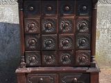 an old wooden chest of drawers with many drawers on it