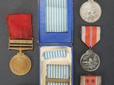 an assortment of medals and medals are displayed in a blue box