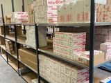 boxes and boxes are stacked on a shelf in a warehouse