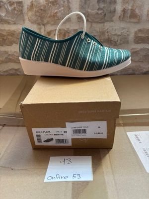 someone is wearing a pair of shoes that are on top of a box