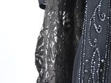 an image of a black dress with sequins and beads on it