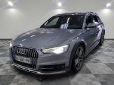 the audi q4 is parked on a checkered floor in a garage