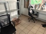 a black office chair and a black chair in a room
