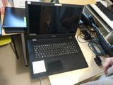 a person sitting at a desk with two laptops on it