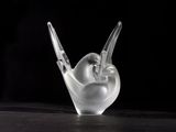 a close up of a glass sculpture of a bird on a table