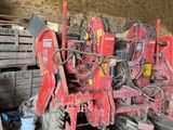 a tractor that is parked next to a pile of wood