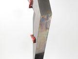 pair of black and silver sculptures with red accents on a black base