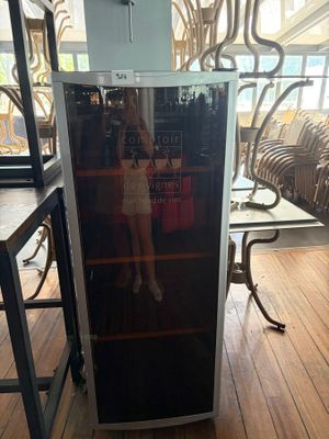 a refrigerator that is sitting on the floor in a room