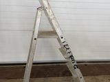 an image of a ladder leaning against a garage wall