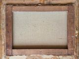 an old picture frame with a piece of wood in the middle of it