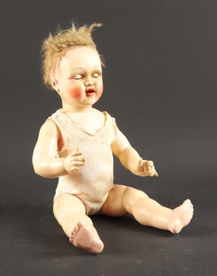 a small doll that is sitting on the ground