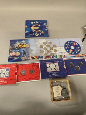 a lot of different coins and coins on the table