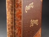 a brown book with gold lettering on it sitting on top of a table