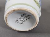 a close up of a vase with a flower design on it