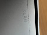 an open laptop computer sitting on top of a wooden table