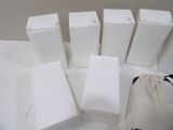 six white boxes of soap sitting on a table next to a drawsack bag