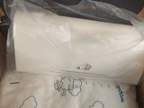 two pillows in a box that have been wrapped in plastic