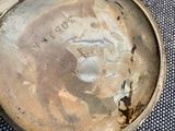 a silver container with a face on it sitting on a table