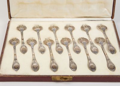 a lot of spoons in a case on the table