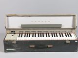 a black suitcase with a piano inside of it