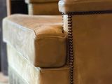 a chair that is sitting in a room with a book on the table
