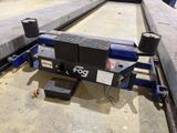 a machine that is sitting on the ground next to a bench