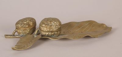 brass figurine of two acorns on a leaf