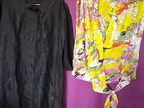 two shirts hanging on a clothes rack in front of a purple wall