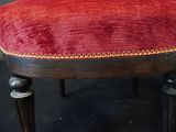 an image of a red and black chair with a gold trim
