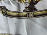 a picture of a close up of a tie with a picture of a sword