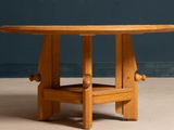 a wooden table with a wooden top on a concrete floor