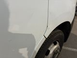 a close up of a white truck parked in a parking lot