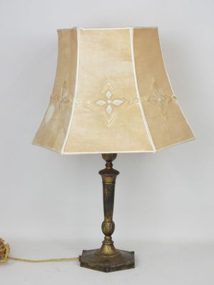 pair of brass table lamps with shades on each side and a lamp shade on the other side