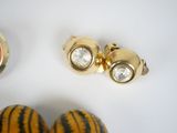 two rings and a pair of earrings sitting on a table