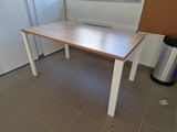a wooden table in the corner of a kitchen
