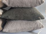 three pillows are stacked on top of each other on a table