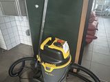 a vacuum that is sitting on the floor in the bathroom