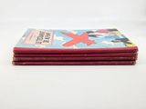 four red books stacked on top of each other on a white surface