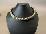 gold twisted rope necklace on a black mannequin display